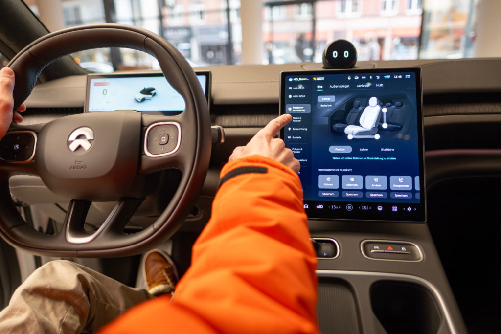 close-up male driver's hand manipulates on electronic display, steering wheel, NIO EL6 Interior, cockpit modern EV, Test Chinese Elektro-SUV, driving safety, Frankfurt, Germany - January 31, 2024